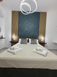 a bedroom with a bed with two towels on it at Sasi Home in Terrasini