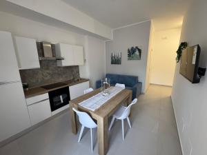 a kitchen and dining room with a table and chairs at Sasi Home in Terrasini