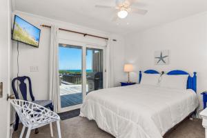 a bedroom with a bed and a sliding glass door at Carolina Clipper East in Emerald Isle