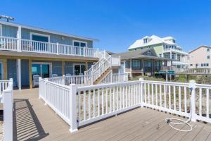 a house with a white railing on a deck at Carolina Clipper East in Emerald Isle