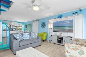 a living room with a couch and a tv at Shady Shack West in Emerald Isle