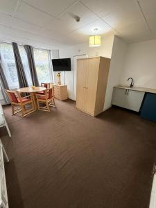 an empty room with a table and a kitchen at Budget Studio - Central Gosport with Free Parking in Gosport