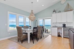 a kitchen and dining room with a table and chairs at Sea Worthy in Indian Beach