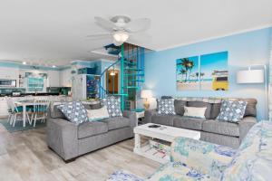 a living room with two couches and a kitchen at Shady Shack East in Emerald Isle