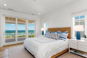 a bedroom with a bed with a view of the ocean at Roosevelt Oceanfront Escape by Emerald Isle Realty in Pine Knoll Shores +161 photos