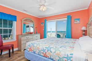 a bedroom with orange walls and a bed and a window at Shady Shack East in Emerald Isle
