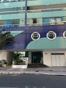 a building with two windows and a staircase on it at Amazing 3 Suite Cobertura - BC in Balneário Camboriú