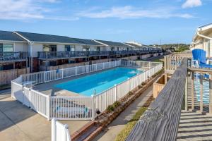 an overhead view of a swimming pool at a resort at Pine Knoll Townes 126 by Emerald Isle Realty in Pine Knoll Shores