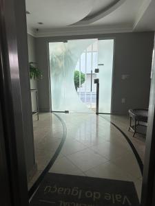 a lobby with a glass door and a table at Amazing 3 Suite Cobertura - BC in Balneário Camboriú +30 photos