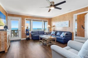 a living room with a couch and a table at Paradise West in Indian Beach