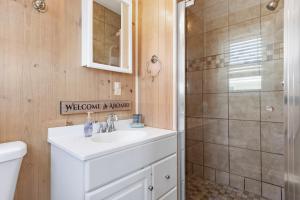 a bathroom with a white sink and a shower at Paradise West in Indian Beach +23 photos