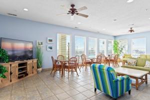 a living room with a television and a table and chairs at Olde Towne Yacht Club 713 in Beaufort