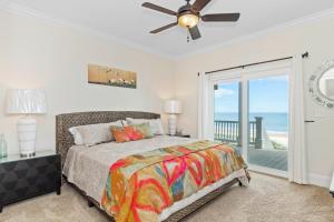 a bedroom with a bed and a ceiling fan at Aqua Vista in Emerald Isle +49 photos