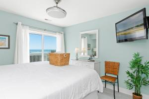 a bedroom with a white bed and a window at All About Bubbles in Indian Beach +73 photos