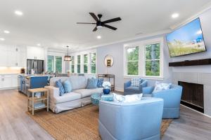 a living room with blue furniture and a fireplace at Afterdune Delight in Cedar Point