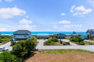 an aerial view of homes with the ocean in the background at A Lil Salt n Lime in Bogue