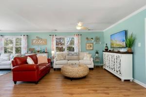 a living room with a red chair and a couch at Bikini Bottom in Cedar Point