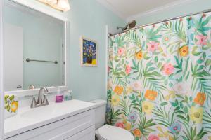 a bathroom with a toilet and a shower curtain at Bikini Bottom in Cedar Point +44 photos