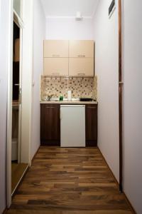 a small kitchen with a sink and a refrigerator at Jasha Apartments in Novi Sad