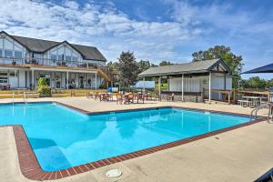 a swimming pool in front of a house at Luxury Home with Game Room, 4 Mi to Bushkill Falls! in Saw Creek