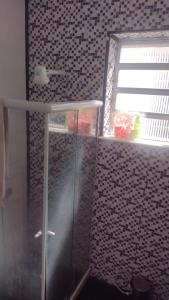 a bathroom with a shower with a glass door at VILA LEME Casa 11A in Rio de Janeiro