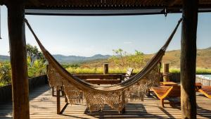 a hammock on a deck with a view at Baguá Bangalôs in Sao Jorge