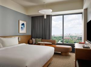 a hotel room with a bed and a large window at The Atlas Hotel in Boston