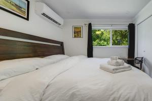 a white bed with a stuffed animal on top of it at Cool & Private 3BR 3BA Near Airport Strong AC in Richmond