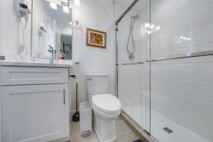 a white bathroom with a toilet and a shower at Cool & Private 3BR 3BA Near Airport Strong AC in Richmond