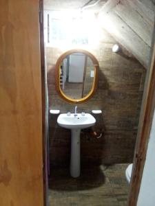 a bathroom with a sink and a mirror at Luli 1 in Villa Gesell +20 photos