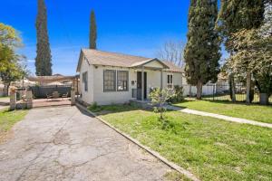 a white house with a porch and a driveway at 2BR Pet-Friendly Home # RV FREE in Upland