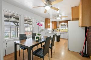 a kitchen with a dining table and a white refrigerator at 2BR Pet-Friendly Home # RV FREE in Upland