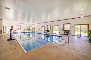 an indoor swimming pool in a large room with a pool at 8-Acre Bridgman Oasis Pool, Hot Tub and Game Room in Bridgman