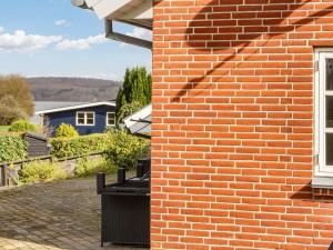a brick wall with a window on a house at Cozy Retreat near Beach - By Traum Ferienwohnungen in Børkop +8 photos