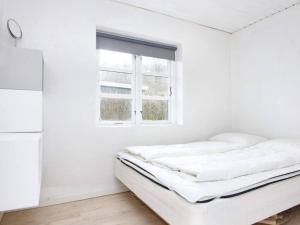 a white room with two beds and a window at Cozy Retreat near Beach - By Traum Ferienwohnungen in Børkop