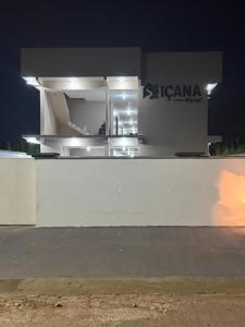 a white building with a sign on it at night at Hotel Içana in São Gabriel da Cachoeira