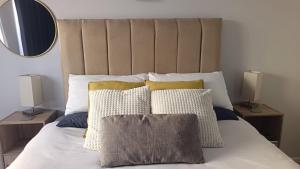 a bedroom with a bed with pillows and a mirror at Relaxing Hideaway in Strand