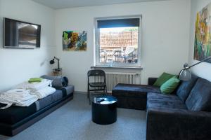 a living room with two couches and a window at Mølvangvej 2 Jelling Apartment in Jelling