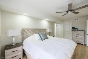 a bedroom with a white bed and a ceiling fan at Main Unit Luxury South Windsor Oasis in Windsor +40 photos