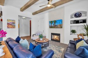 a living room with a couch and a fireplace at Luxurious Remodeled Villa in La Quinta #A in La Quinta
