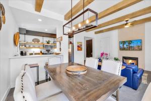 a kitchen and dining room with a wooden table and chairs at Luxurious Remodeled Villa in La Quinta #A in La Quinta