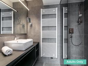 a bathroom with a sink and a shower at Adult Only Superior Suite in Niederhof +32 photos