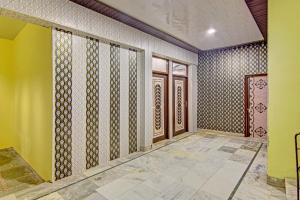 a room with yellow walls and brown doors at Hotel O Cozy Cottage in Meerut +32 photos