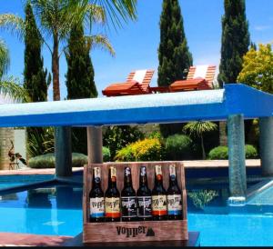 a box of bottles of wine sitting next to a swimming pool at Casa Diamante Hotel Boutique - Mineral de Pozos in Mineral de Pozos