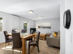 a dining room and living room with a table and chairs at Direkt an der Ostsee - Helma in Zierow