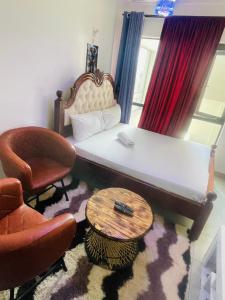 a living room with a couch and a table and chairs at Happy day homes in Nairobi