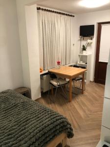 Un dormitorio con una mesa, una cama y un escritorio. en Gemütliches Studio Ohlendorf, en Seevetal