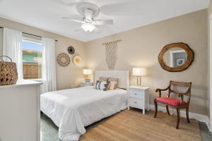 a bedroom with a bed and a chair and a mirror at 172 Woodland Ave in Cocoa Beach