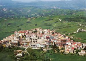 a town on top of a green hill with houses at Perbacco in SantʼAngelo Limosano