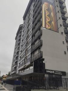 a large building with a sign on the side of it at Apartment in the center 500 meters from Proeb in Blumenau